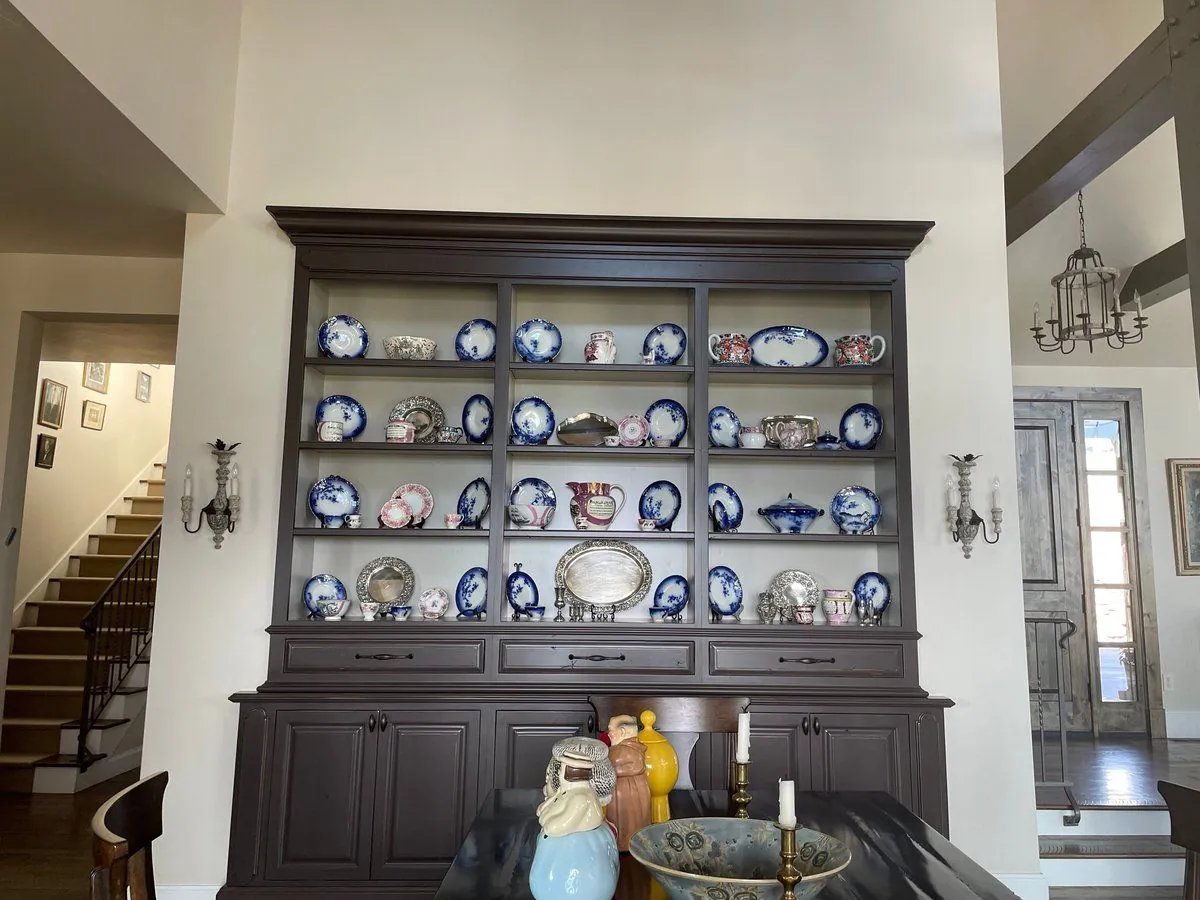 Dining room before: an espresso hutch filled with blue and white china